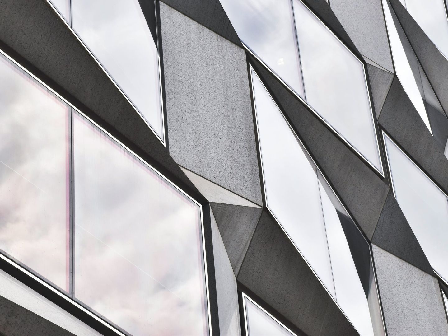 Close crop of angular glass and steel panels on a building exterior