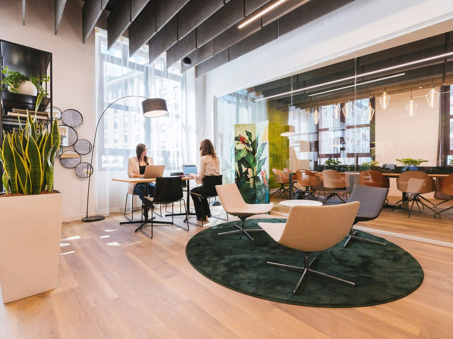 A modern open-plan coworking space with lounge seating