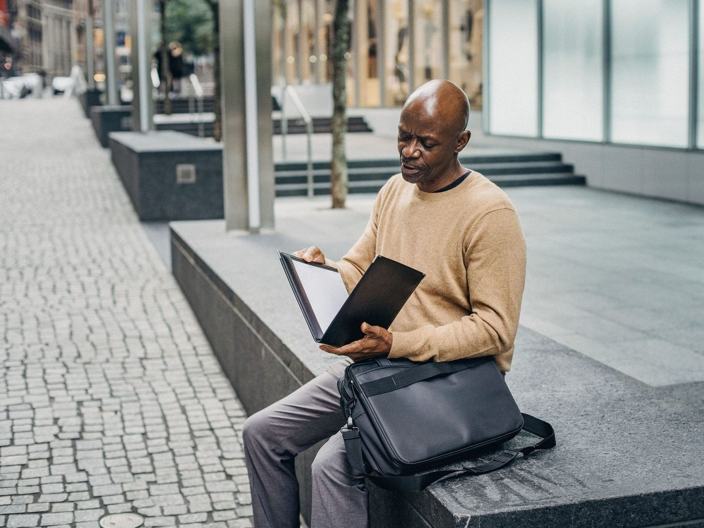 A founder at a bank meeting with a document folder